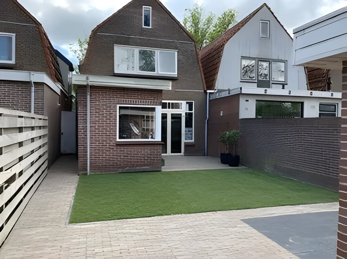 Dezelfde stadstuin na de aanleg, met gazon en nieuwe bestrating